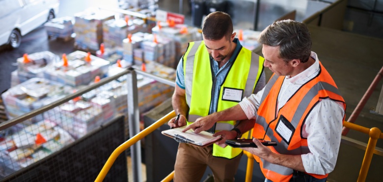 Two employees locating shipments.